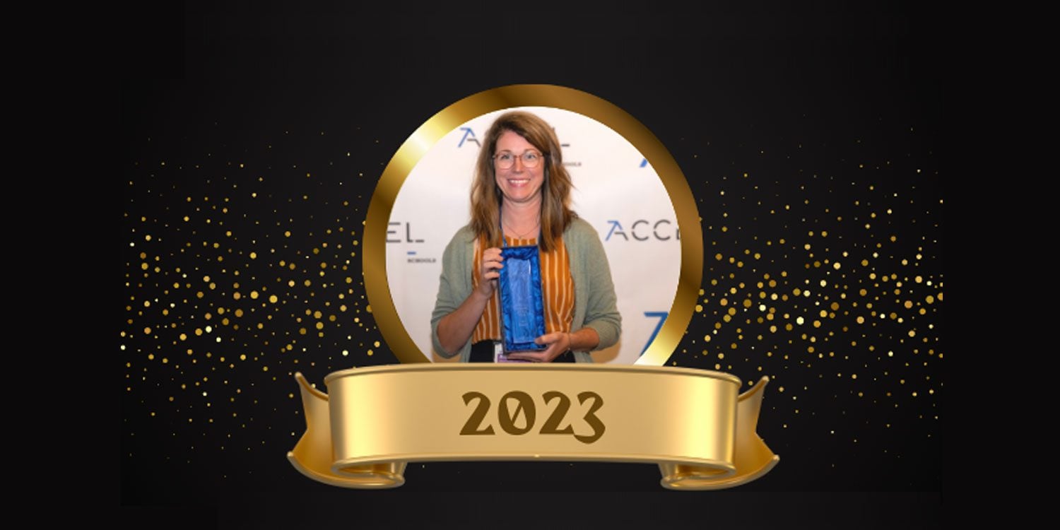Smiling woman holding a blue award trophy, with "2023" on a banner.